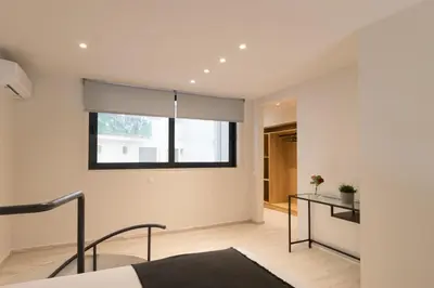a bedroom with a bed and a window at Voda Luxury Residence #002 - Acropolis View Rooftop in Athens