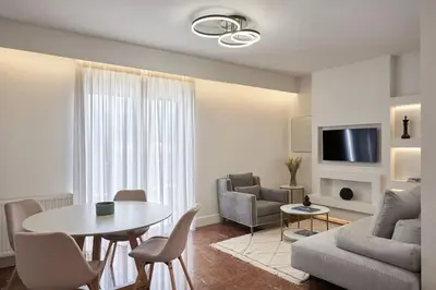 a living room with a table and a couch at A Sunkissed retreat under the Acropolis in Athens