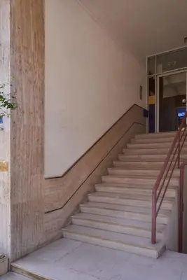 a set of stairs in a building with a glass door at A Sunkissed retreat under the Acropolis in Athens