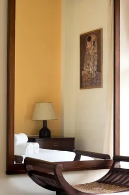 a mirror in a room with two beds and a lamp at Tati's Parthenon apt 2bdr with balcony in Athens