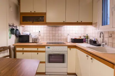 a kitchen with a stove and a sink at Tati's Parthenon apt 2bdr with balcony in Athens