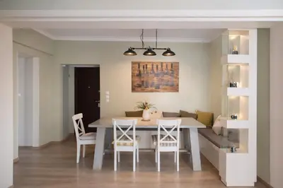 a kitchen and dining room with a table and chairs at Acropolis Area Large 3BR 2BA Apartment in Athens