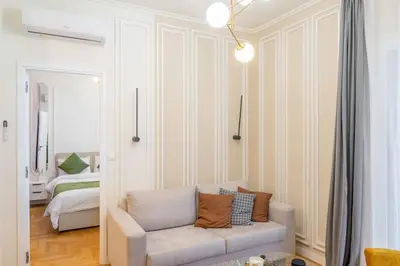 a living room with a couch and a bedroom at Lux 2 bedroom apt next to metro in Athens
