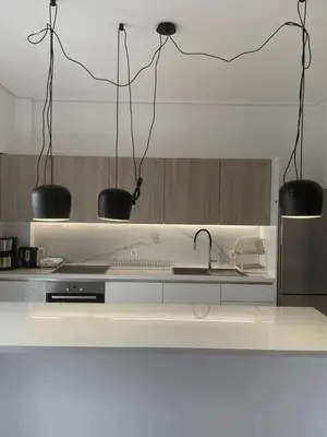 a kitchen with two black lights above a sink at Downtown City Apartment in Athens