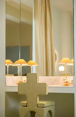 a cross on a bench in front of a mirror at Apollo Palm Hotel in Athens