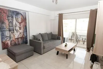 a living room with a couch and a table at Fully equipped flat in Piraeus (Erm_C7) in Piraeus