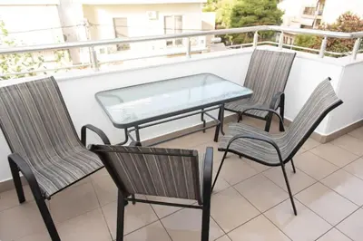a glass table and chairs on a balcony at Fully equipped flat in Piraeus (Erm_C7) in Piraeus