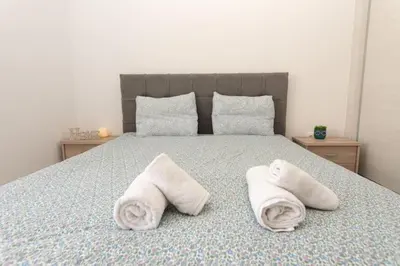 a bedroom with a bed with towels on it at Fully equipped flat in Piraeus (Erm_C7) in Piraeus