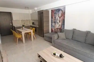 a living room with a gray couch and a table at Fully equipped flat in Piraeus (Erm_C7) in Piraeus