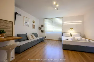 a living room with a bed and a couch at Nesto Athens Airport Zen in Spáta