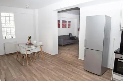 a kitchen and dining room with a table and a refrigerator at City view modern apartment (D3_FAL) in Athens