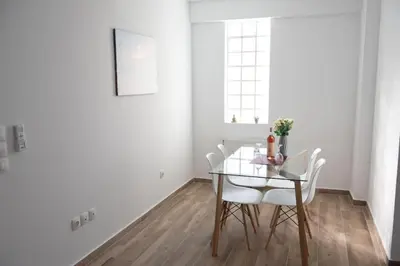 a dining room with a glass table and white chairs at City view modern apartment (D3_FAL) in Athens