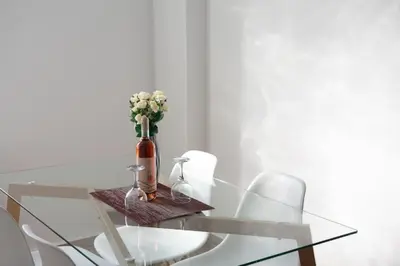 a glass table with a vase with flowers on it at City view modern apartment (D3_FAL) in Athens
