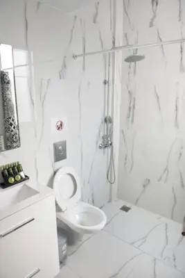 a white bathroom with a toilet and a sink at City view modern apartment (D3_FAL) in Athens