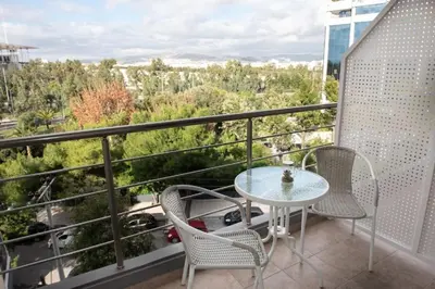 a patio with a table and chairs on a balcony at City view modern apartment (D3_FAL) in Athens