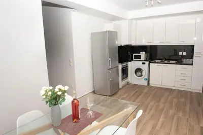 a kitchen with a glass table and a refrigerator at City view modern apartment (D3_FAL) in Athens