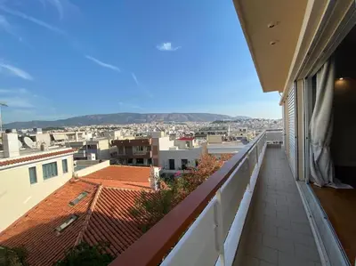 a balcony with a view of a city at 2-bedroom apartment in Athina (Filopappou) in Athens