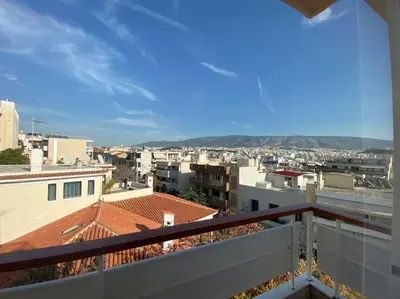 a view of a city from a balcony at 2-bedroom apartment in Athina (Filopappou) in Athens