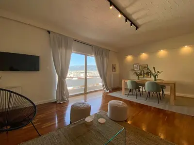 a living room with a table and a dining room at 2-bedroom apartment in Athina (Filopappou) in Athens