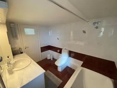 a bathroom with a toilet and a sink and a tub at 2-bedroom apartment in Athina (Filopappou) in Athens