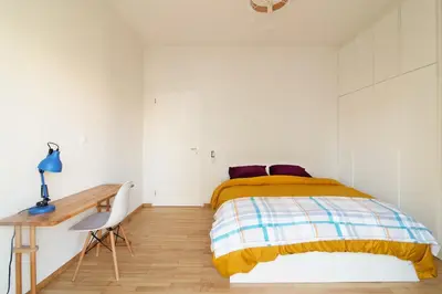 a white bedroom with a bed and a desk at Luxury 1-Bedroom Apartment by the Sea in Athens in Athens