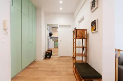 a hallway with green and white walls and a wooden ladder at Luxury 1-Bedroom Apartment by the Sea in Athens in Athens