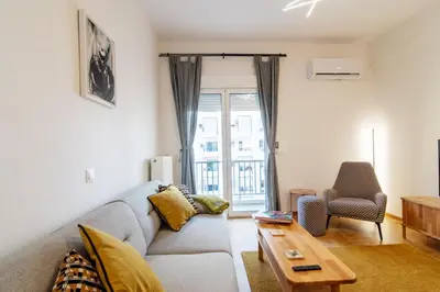 a living room with a couch and a table at Luxury 1-Bedroom Apartment by the Sea in Athens in Athens