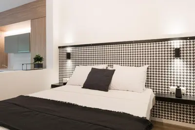 a bedroom with a bed with a black and white headboard at Voda Luxury Residence #101 - Acropolis View Rooftop in Athens