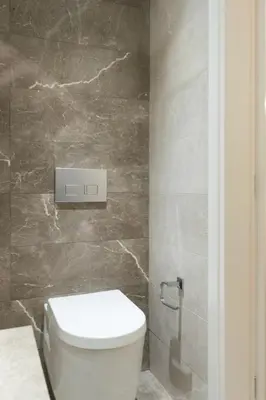 a bathroom with a white toilet and a stone wall at Voda Luxury Residence #101 - Acropolis View Rooftop in Athens