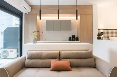 a living room with a couch and a kitchen at Voda Luxury Residence #101 - Acropolis View Rooftop in Athens