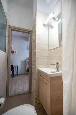 a bathroom with a sink and a mirror at Athens center 2 persons flat by MPS in Athens