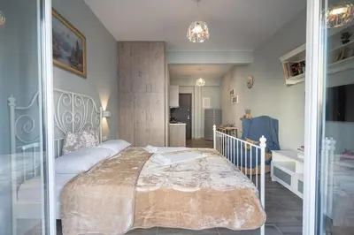 a bedroom with a large bed and a bathroom at Athens center 2 persons flat by MPS in Athens