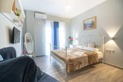 a bedroom with a bed and a living room at Athens center 2 persons flat by MPS in Athens