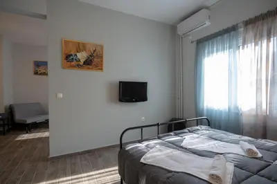 a bedroom with a bed and a tv and a window at Athens center 1 bedrm 4 pers apartment by MPS in Athens