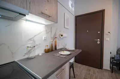 a kitchen with a counter top and a black door at Athens center 1 bedrm 4 pers apartment by MPS in Athens
