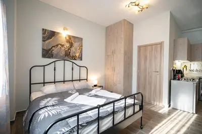 a bedroom with a bed and a kitchen at Athens center 1 bedrm 4 pers apartment by MPS in Athens