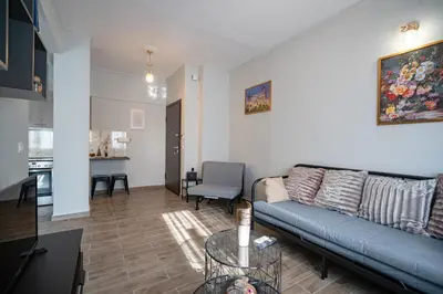 a living room with a blue couch and a table at Athens center 1 bedrm 4 pers apartment by MPS in Athens