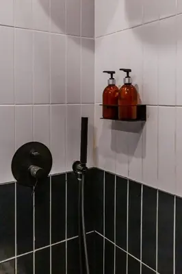 a bathroom with a hose hooked up to a shower at SoHo Athinas 60 in Athens