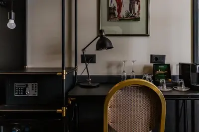 a desk with a lamp and a chair in a room at SoHo Athinas 60 in Athens