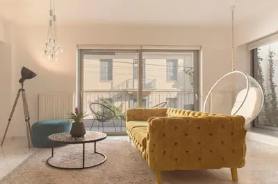 a living room with a couch and a table at Living Stone Bronze in Athens