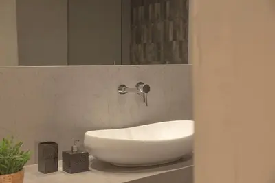 a bathroom with a white sink and a mirror at Living Stone Bronze in Athens