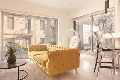 a living room with a yellow couch and a table at Living Stone Bronze in Athens