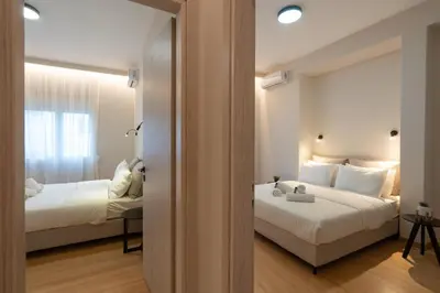 a hotel room with two beds and a window at Athens Hippest Apartment in Athens