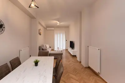 a living room with a table and a couch at Athens Hippest Apartment in Athens