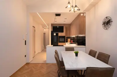 a kitchen and dining room with a table and chairs at Athens Hippest Apartment in Athens