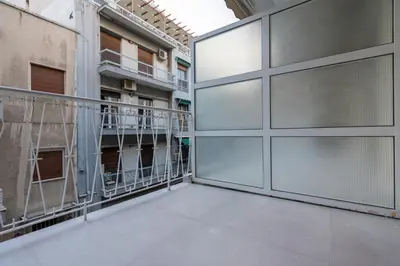 a balcony with glass doors in a building at Athens Hippest Apartment in Athens