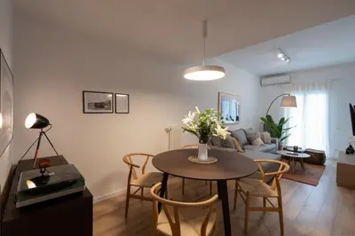 a living room with a table and a couch at Unique 2 Bedrooms Apartment, Steps to Plaka and City center in Athens