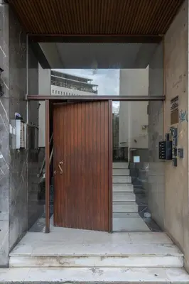 a large wooden door in a building with stairs at Unique 2 Bedrooms Apartment, Steps to Plaka and City center in Athens