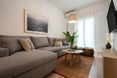 a living room with a couch and a table at Unique 2 Bedrooms Apartment, Steps to Plaka and City center in Athens
