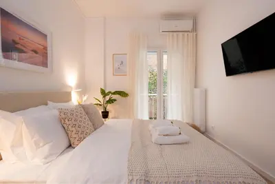 a bedroom with a white bed with towels on it at Unique 2 Bedrooms Apartment, Steps to Plaka and City center in Athens